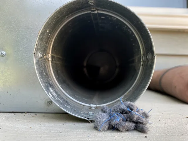 Gastonia Dryer Vent Cleaning technician using specialized equipment to clear severe dryer vent blockage in Gastonia